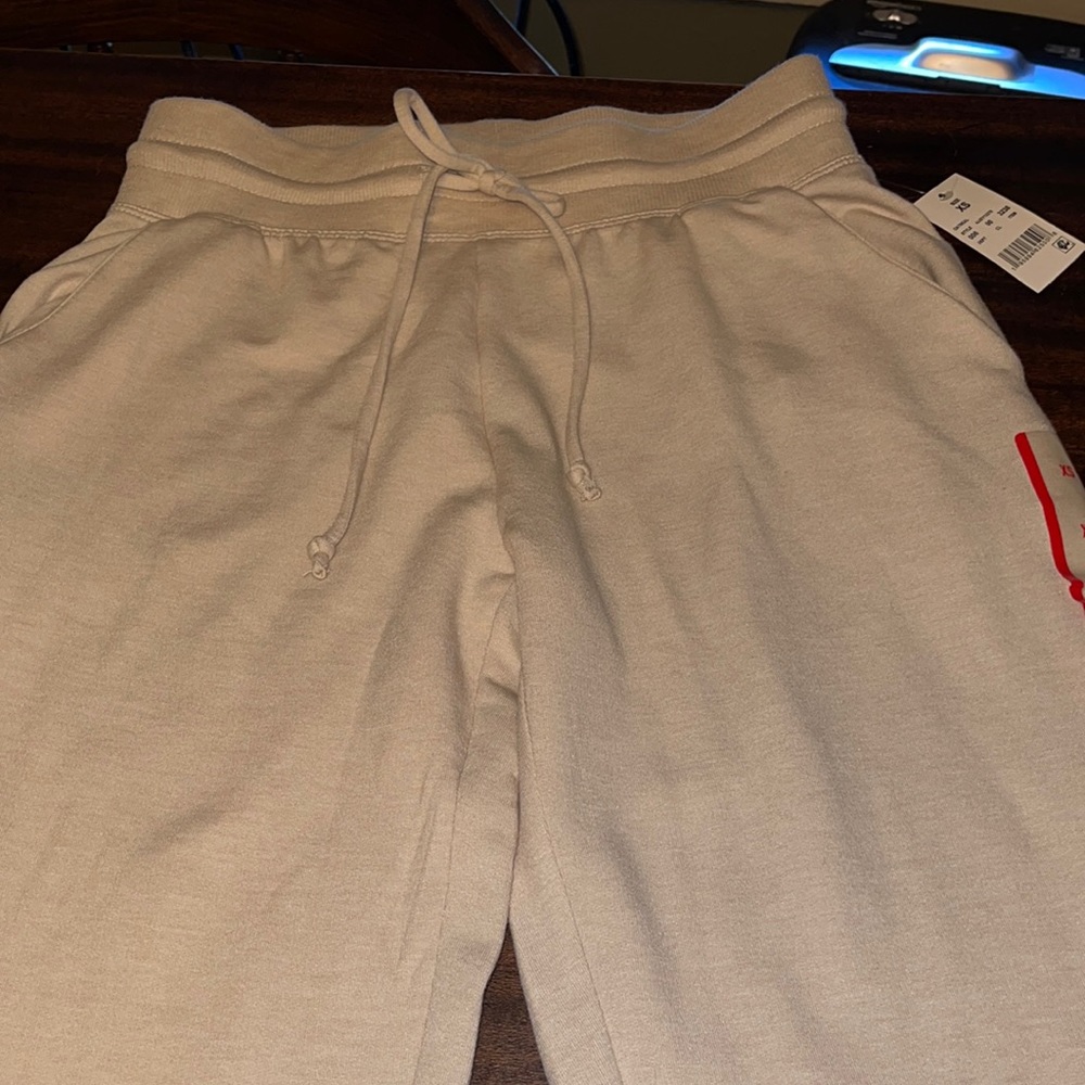 NWT tan joggers with Mickey Mouse on the leg
